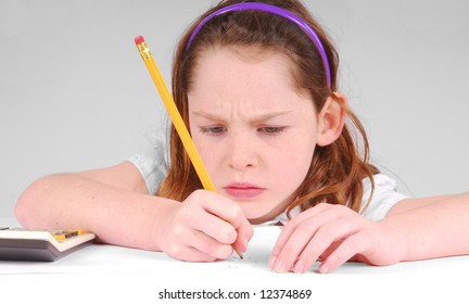 Young girl looking serious while concentrating on work