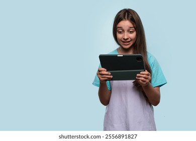 Young girl looking surprised while reading something on her tablet. - Powered by Shutterstock