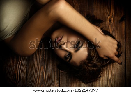 Similar – Young woman in black lingerie in chiaroscuro lighting