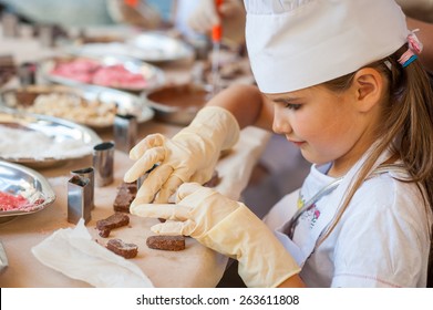 Young girl making chocolate candy