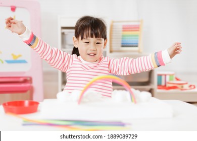 Young Girl Making Rainbow Craft Using Pipe Cleaner At Home 