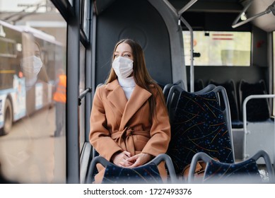 A young girl in a mask uses public transport alone, during a pandemic. Protection and prevention covid 19