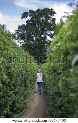 Young girl in a maze looking for the way out.