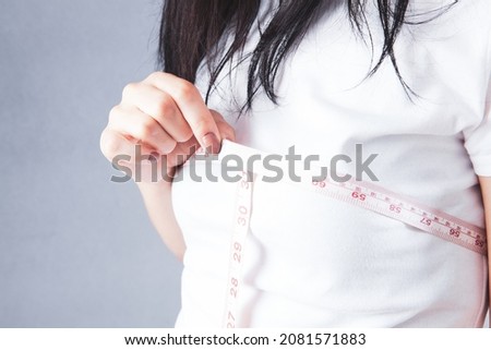 young girl measures her breasts