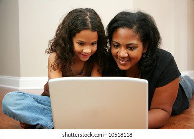 Young girl with mother on the computer
