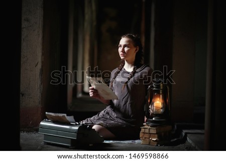 A young girl with old books in the old house
