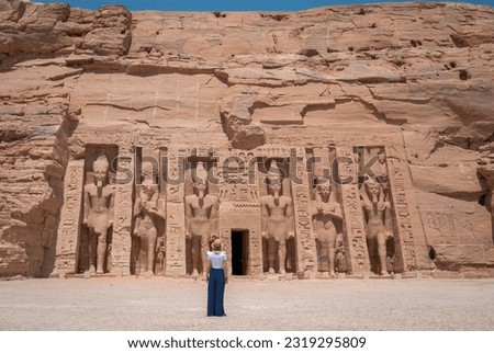 Young girl on her back enjoying the temple of Abu Simbel on her trip through Egypt. Temple of Queen Nefertari.