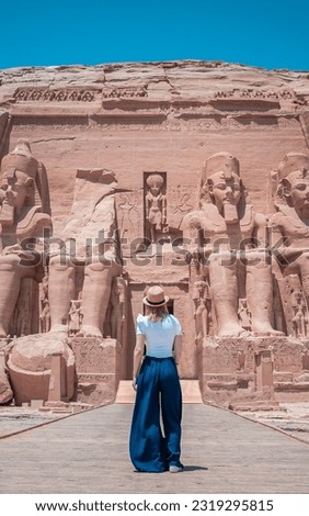 Young girl on her back enjoying the temple of Abu Simbel on her trip through Egypt.