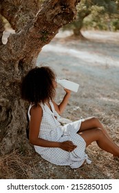 Young Girl On Safari Nature Drink Milk In Sundress And Hat. Afro Hair, Ecology, Health, Milk Bottle, Brunette, Afro Hair, Relaxation, Tranquility, Farm Products