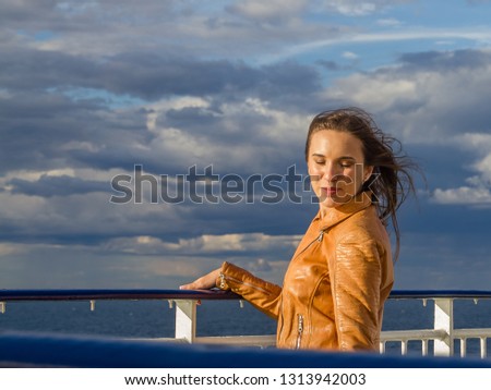 Young girl on a sea voyage in the setting sun