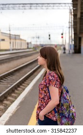 Young girl on train station platform with bags - Shutterstock ID 315842237