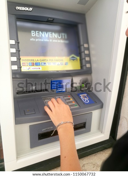 Young Girl operating an ATM\
Automatic Teller Machin in Dubrovnik,Croatia-July\
2018