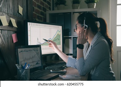 young girl operator helping customer analysis financial risk and using pen pointing the graphic. woman servicer wear suit sitting in office. - Powered by Shutterstock