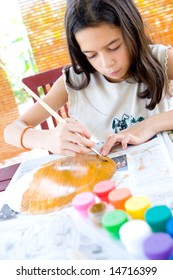 Young Girl Painting A Paper Plate In Arts And Craft.