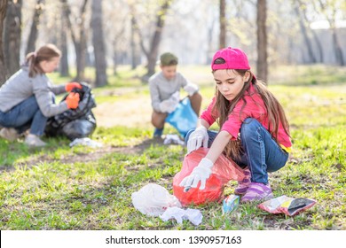 Young girl picking up trash in the park. Volunteer concept - Powered by Shutterstock