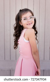 A Young Girl With Pink Glasses Is Excited And Nervous For Her First Day Of School.
