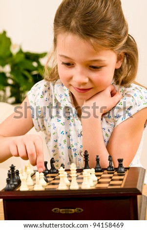 Similar – lifestyle shot of smart kid girl playing checkers at home