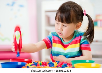 young girl play math and color sorting fine motor skill game for  homeschooling - Powered by Shutterstock