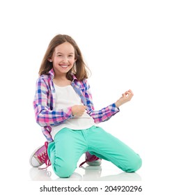 Young Girl Playing The Air Guitar. Full Length Studio Shot Isolated On White.