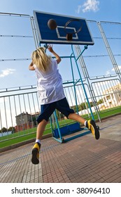 Young Girl Playing Basketball Outside