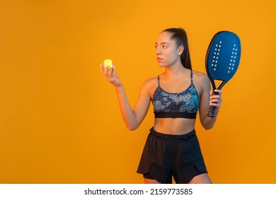 Young girl playing beach tennis on yellow color background . Professional sport concept. Horizontal sport theme poster, greeting cards, headers, website and app - Powered by Shutterstock