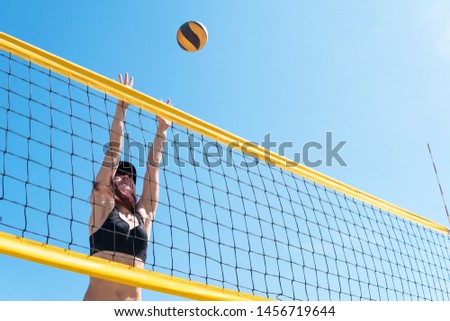 young girl playing beach volleyball. Beach volley ball match. Outdoor sports activities, vacation fun time.