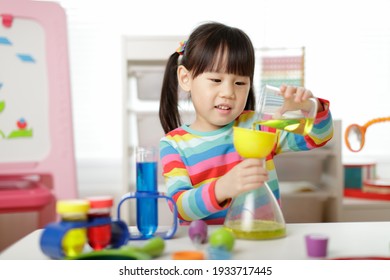 young girl playing color sorting and fine motor skill toy at hom
