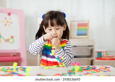 young girl playing creative blocks for home schooling