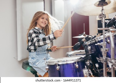 Young Girl Playing Drums In Music Studio