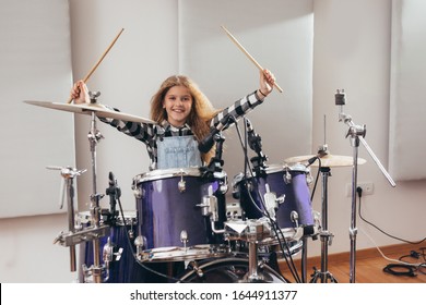 Young Girl Playing Drums In Music Studio