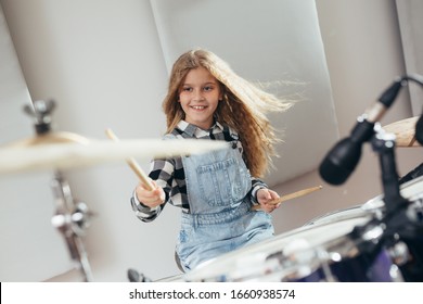 Young Girl Playing Drums At The Music Studio