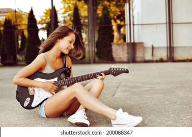 Young Girl Playing Guitar - Outdoor Portrait 