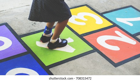 Young Girl Playing Hopscotch