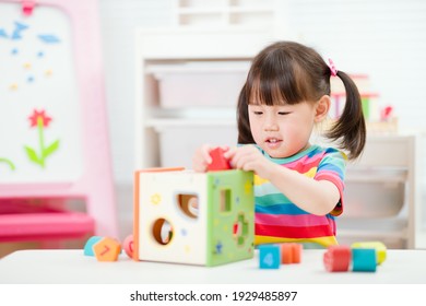 young girl playing number shape blocks for homeschooling
