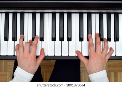 Young girl playing the piano. Child practicing on the modern electric piano at home. Music lesson. Close-up. High angle view. - Powered by Shutterstock