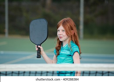 Young Girl Playing Pickleball On An Outdoor Court. 