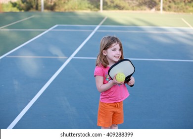 Young Girl Playing Pickleball On An Outdoor Court. 