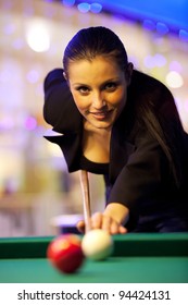 Young girl playing snooker