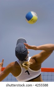 Young girl playing volleyball in the beach