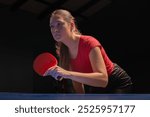 Young girl plays table tennis closeup