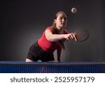 Young girl plays table tennis closeup