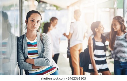 Young girl, portrait and lonely with school bag outside classroom in learning academy or institute. Female person, teenager or learner leaning on glass wall alone with arms crossed at outdoor campus - Powered by Shutterstock