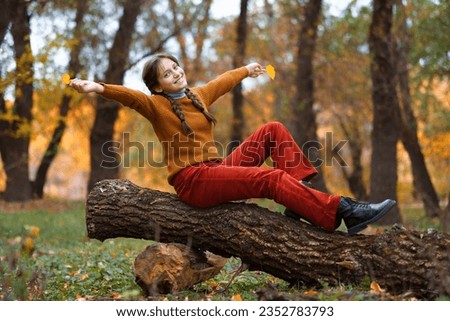 a young girl poses in autumn forest, fall season, beautiful nature
