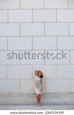 Similar – Image, Stock Photo Happy woman jumping in front of stone wall background