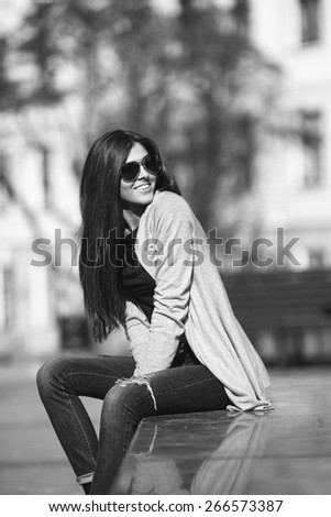 beautiful young woman smiling while walking in the park