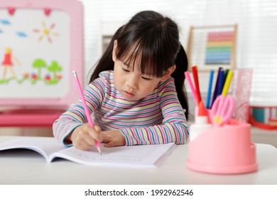 Young Girl Practice Writing Letters For Home Schooling