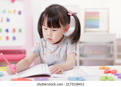 Young Girl Practice Writing Letters For Homeschooling