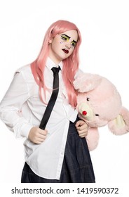 young girl with professional comic pop art make-up holding teddy bear. Funny cartoon or comic strip make-up.
