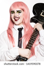 young girl with professional comic pop art make-up holding electric guitar. Funny cartoon or comic strip make-up