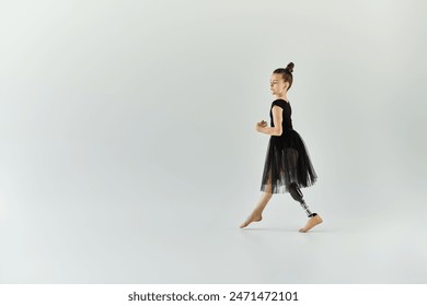 A young girl with a prosthetic leg performs a graceful leap during a gymnastics routine. - Powered by Shutterstock